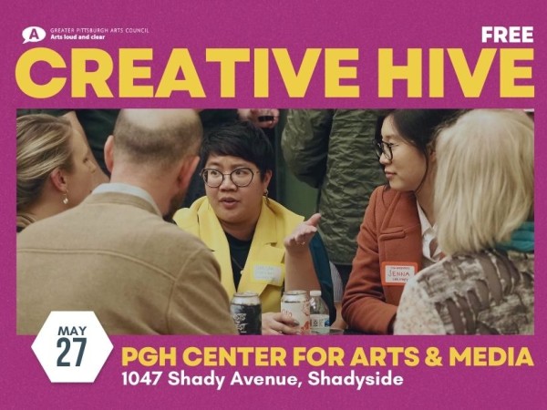 A group of people sit at a table networking inside an event space. Creative Hive on May 27 at Pittsburgh Center for Arts & Media