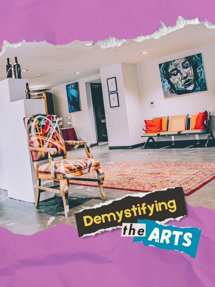 Artwork is displayed inside a building. The words Demystifying the Arts is placed on top