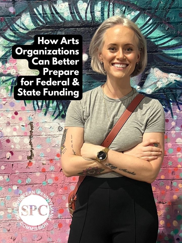 A smiling white woman with short straight blonde hair poses in front of a colorful mural. Text reads, How Arts Organizations Can Better Prepare for Federal & State Funding