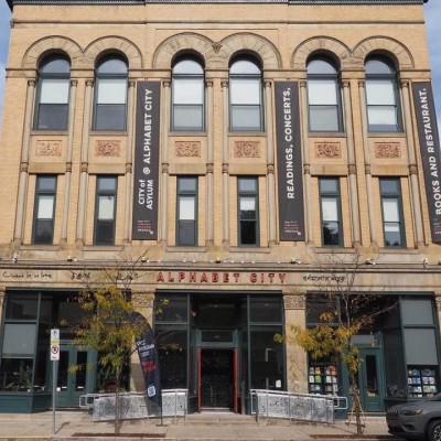 A picture of a building with red text that says Alphabet City