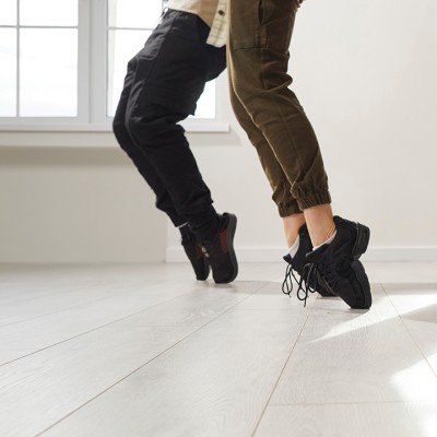 Cropped photo of two pairs of dancing legs and feet